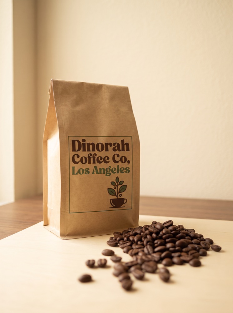 A kraft bag of Dinorah Coffee Co beans with roasted beans spilled beside it